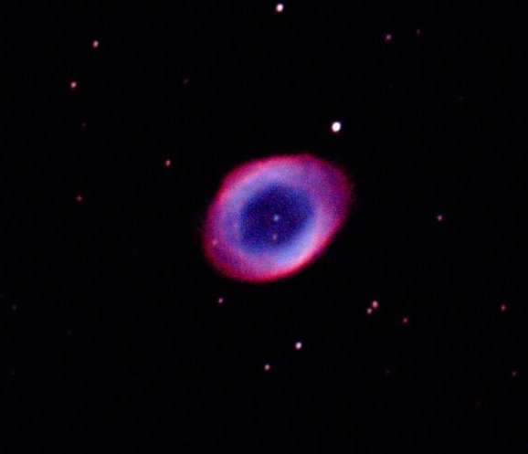 The Ring Nebula, a bright elliptical ring with a faint central star